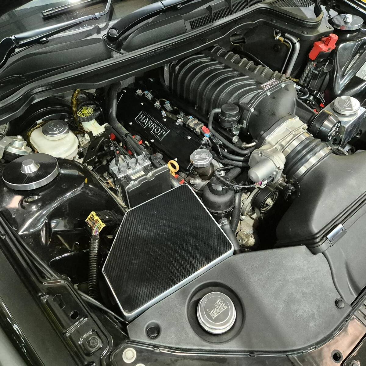 Harrop-branded supercharged LS2 with carbon covers in a black HSV VE GTS