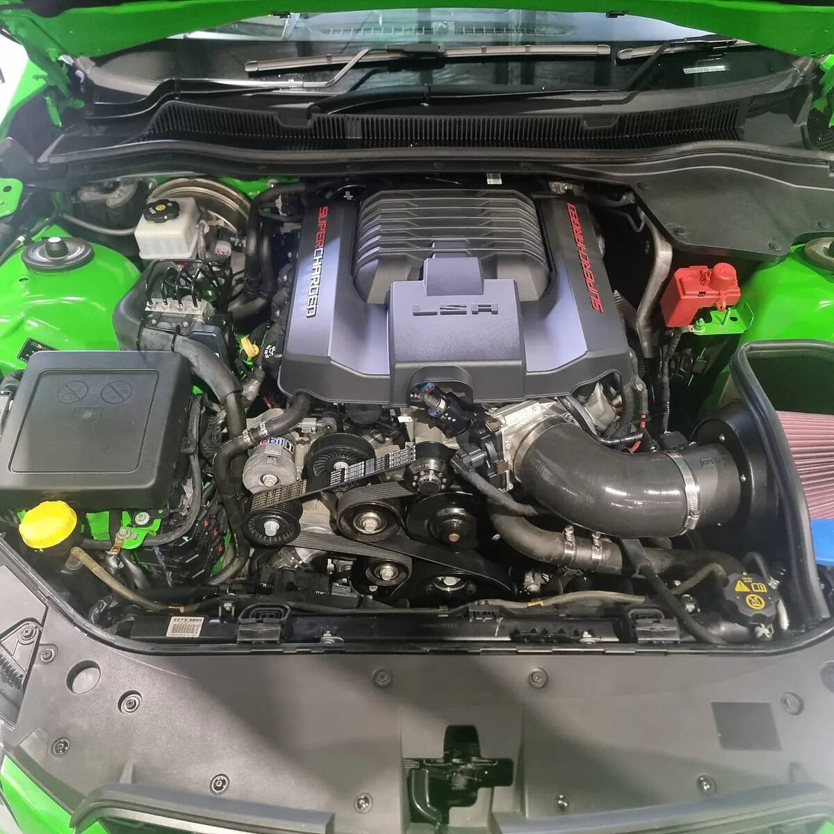 Supercharged LSA engine bay of a green HSV VF Clubsport with a boosted pulley and cold air intake