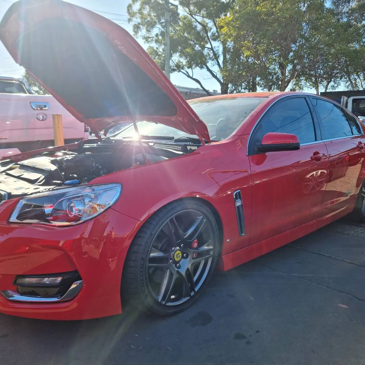 Red Holden VF SS with a Harrop 2650 supercharger, bonnet up in the afternoon sun